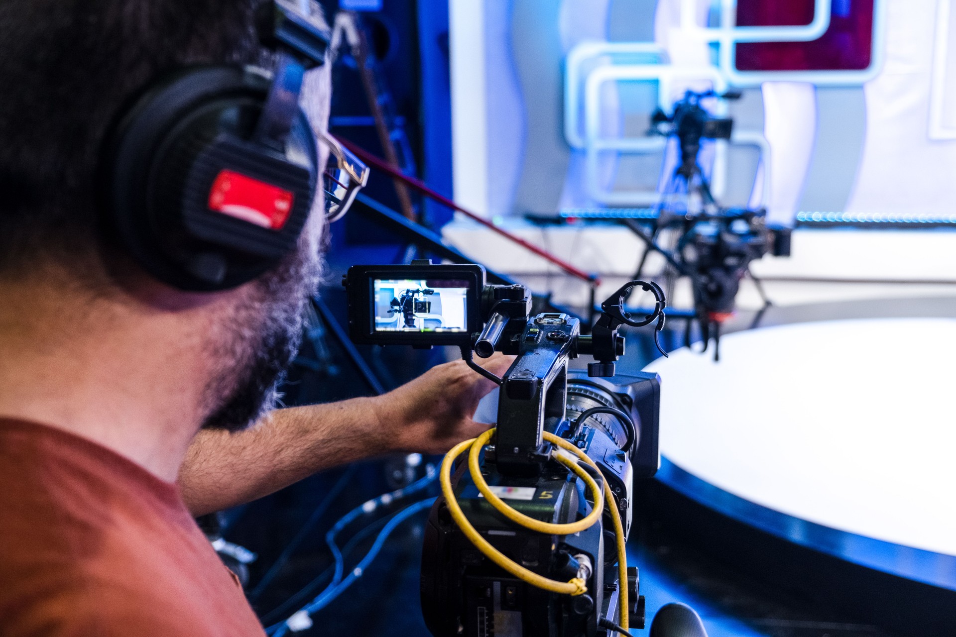 Television camera operator operating a digital camera in a television studio